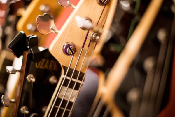 Range of guitars including Fender Jazz Bass, Martin 0001x Metal String Guitar
